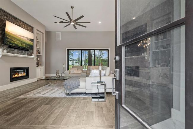 Step into your new home and be welcomed by a breathtaking open-concept living space, where soaring ceilings create an atmosphere of grandeur and elegance. | Image 7