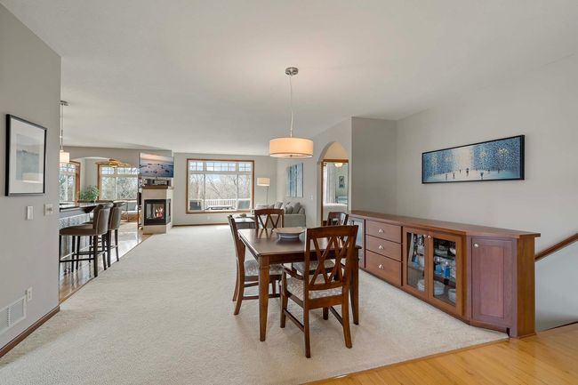 The open-concept dining, living, kitchen and sunroom is lit with natural light in this end-unit. | Image 4