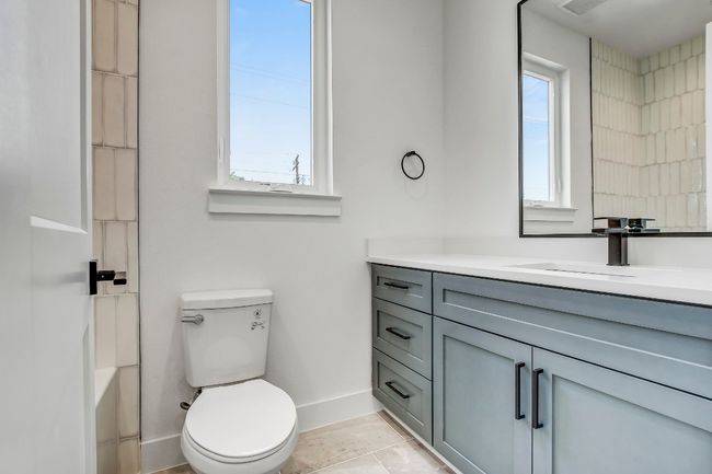 Full bath with vanity, baseboards, toilet, and a shower | Image 22
