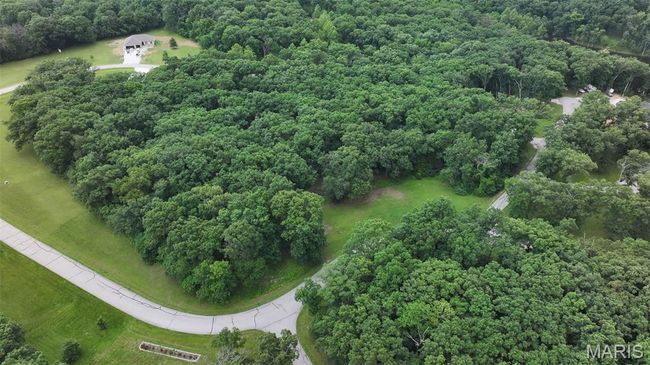 Aerial view of a heavily wooded area | Image 28