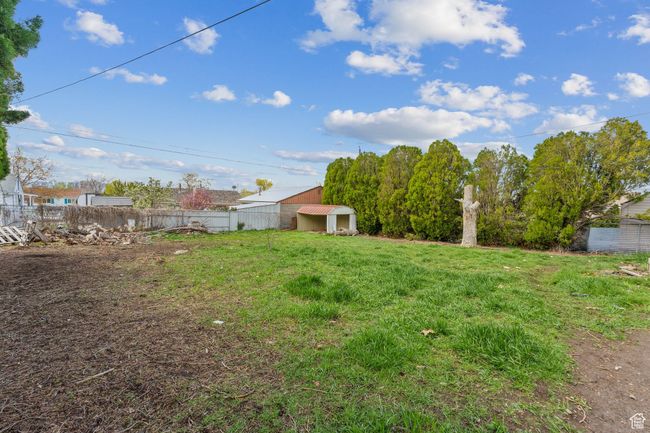View of yard with an outbuilding, a shed, and fence | Image 31