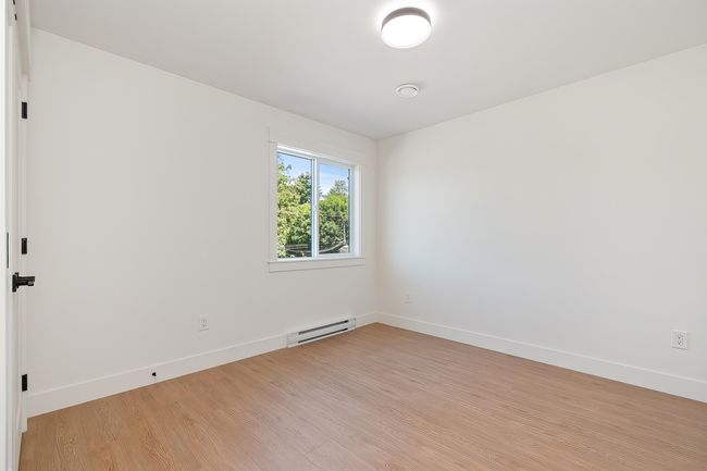 Unfurnished room with baseboard heating and light wood-style flooring | Image 28