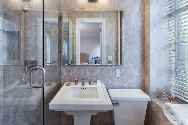Full bath featuring a stall shower and tile walls | Image 17
