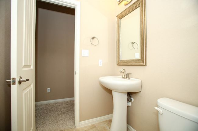 Half bathroom featuring toilet and baseboards | Image 24