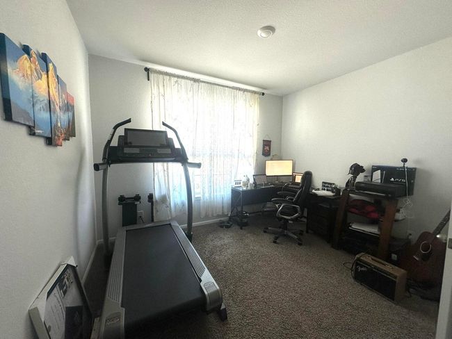 Home office featuring carpet and a textured ceiling | Image 6