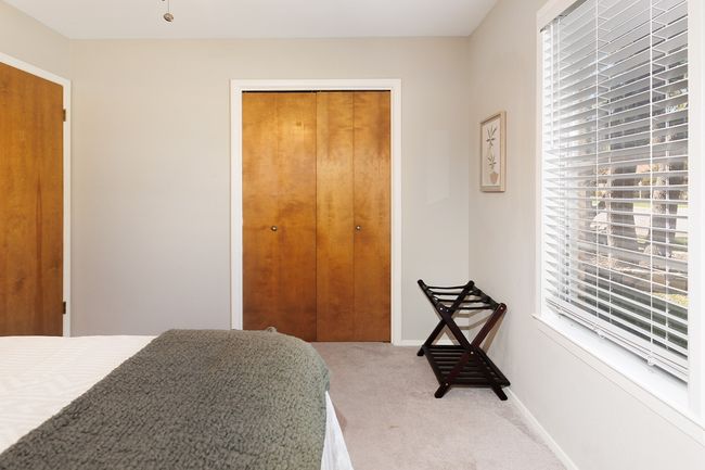 Bedroom with baseboards, carpet flooring, multiple windows, and a closet | Image 31