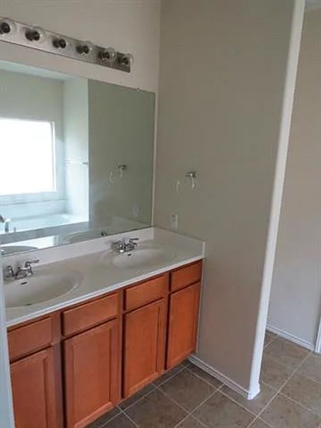 Bathroom with double vanity, a bath, and tile patterned flooring | Image 8