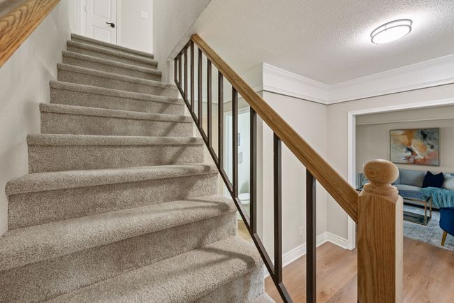 Upstairs, you'll find 4 bedrooms and 2 bathrooms, including the primary bedroom and bathroom. | Image 21