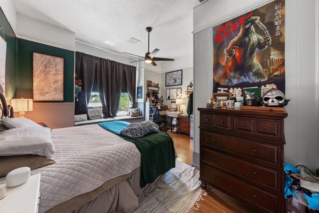 Bedroom with wood finished floors, a textured ceiling, and ceiling fan | Image 21