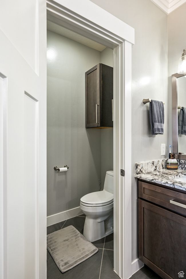 Half bathroom featuring vanity and tile patterned floors | Image 43