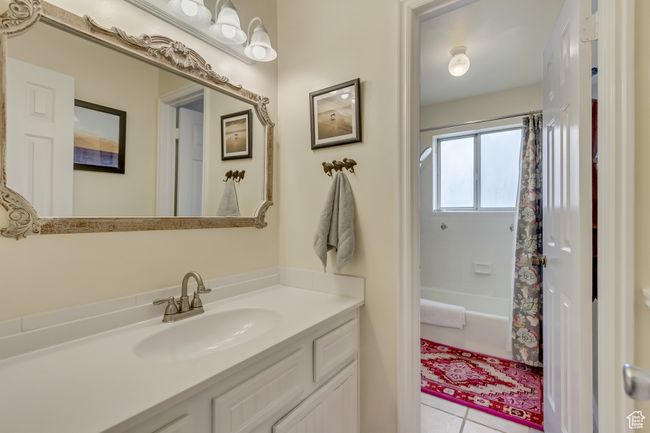 Full bath featuring shower / tub combo, tile patterned floors, and vanity | Image 31