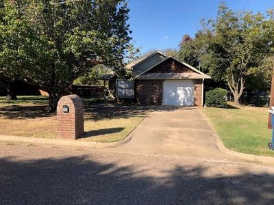 View of front facade featuring a garage and a front lawn | Image 2