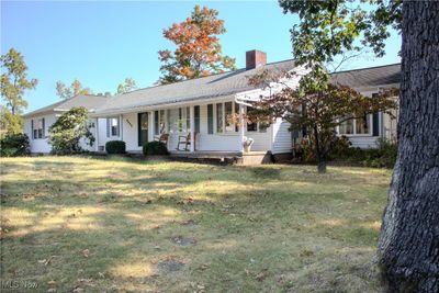 Ranch-style home featuring covered porch and a front yard | Image 2