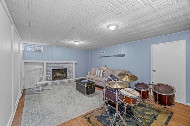Wood burning fireplace in basement providing extra warmth | Image 31