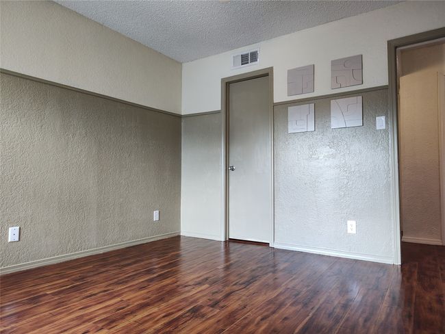 Unfurnished bedroom featuring dark hardwood / wood-style flooring | Image 9