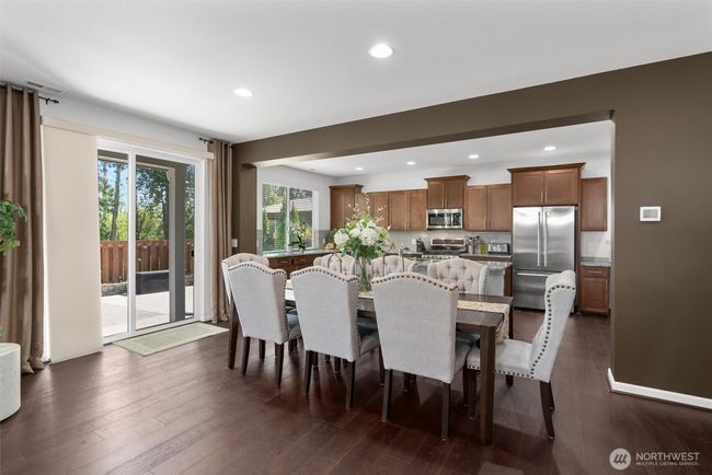 The spacious dining area is ideal for entertaining, hosting holidays, or everyday living! This layout offers stylish finishes and easy access to the backyard patio! | Image 7
