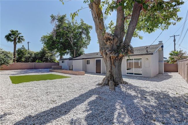 Back of house featuring a fenced backyard, a patio, and stucco siding | Image 32