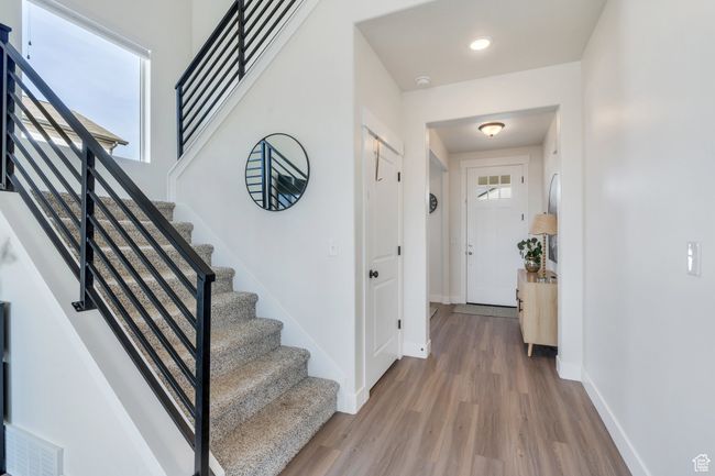 Interior space with visible vents, recessed lighting, stairway, wood finished floors, and baseboards | Image 11