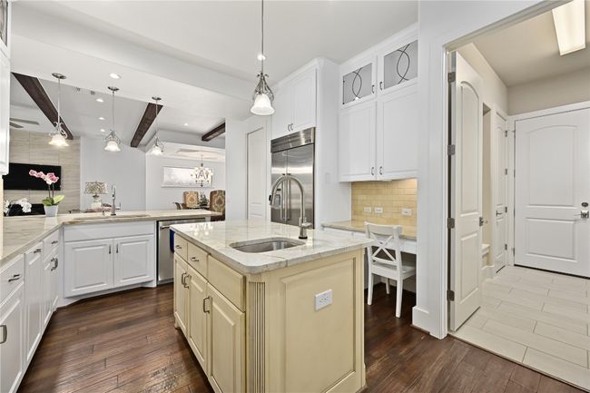 Kitchen featuring a sink, appliances with stainless steel finishes, dark wood-type flooring, decorative backsplash | Image 9