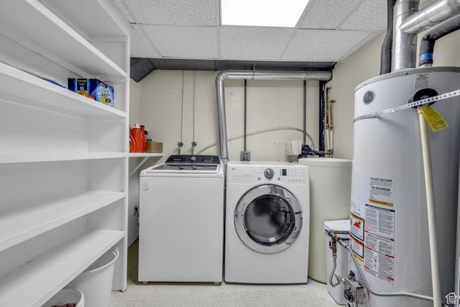 Washroom featuring double secured water heaters and washing machine and clothes dryer | Image 29