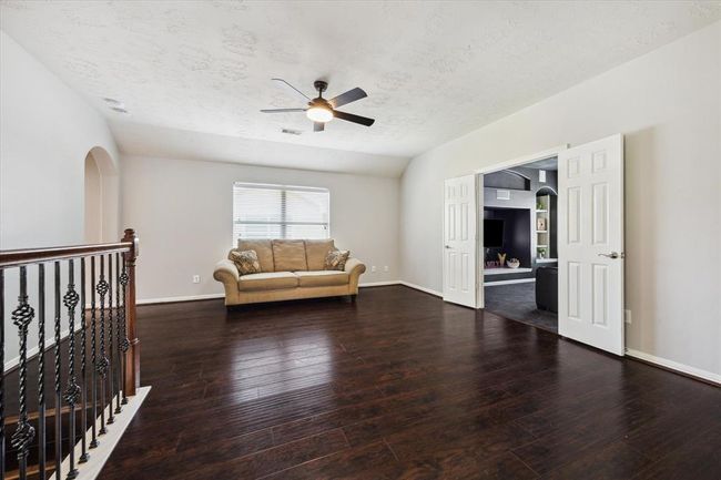 A family sized game room with a new fan (2/24), beautiful engineered flooring and window blinds. The media room is adjacent on the right. | Image 37