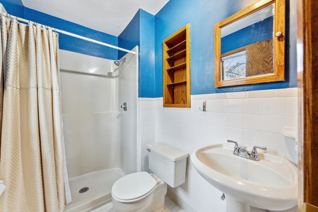Private owners suite 3/4 bathroom with tile floors and walk-in shower | Image 11