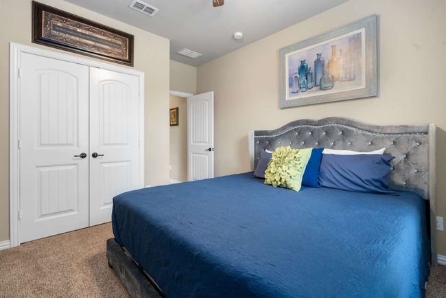 Bedroom with carpet flooring, a closet, and baseboards | Image 14