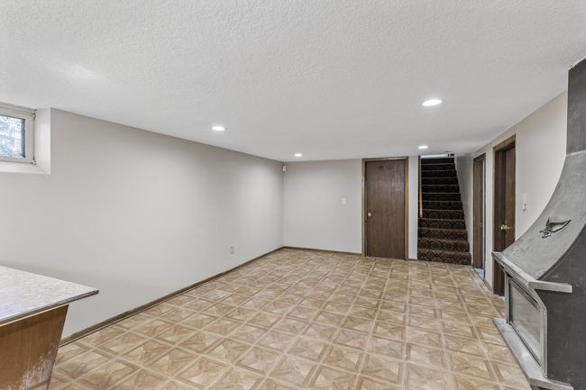 Walk down to the large family room in the lower level. | Image 21