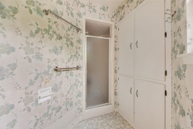 Bathroom with wallpapered walls and a shower stall | Image 26
