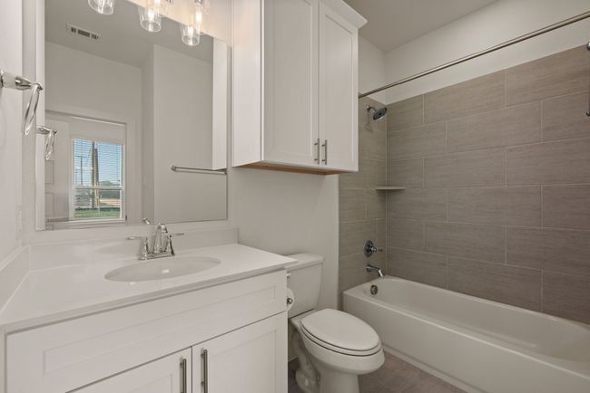 Full bathroom with shower / bathtub combination, visible vents, toilet, and vanity | Image 9