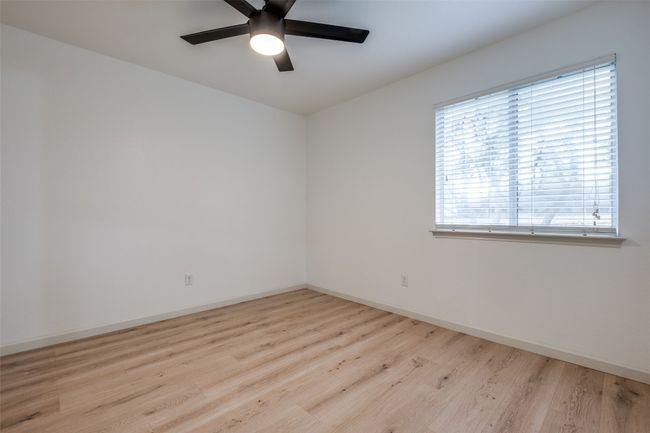 Spare room featuring baseboards, a ceiling fan, and wood finished floors | Image 16