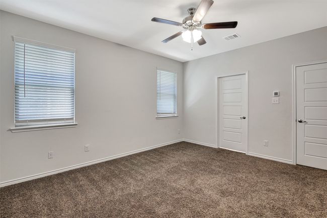 Empty room featuring dark carpet and ceiling fan | Image 6