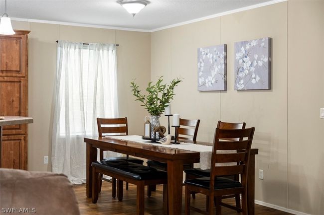 Dining room featuring dark hardwood / wood-style floors and crown molding | Image 12