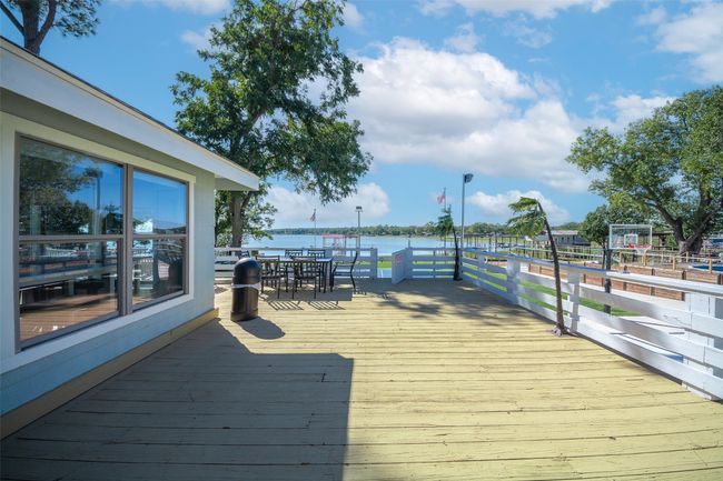 Wooden terrace with outdoor dining space and a water view | Image 9
