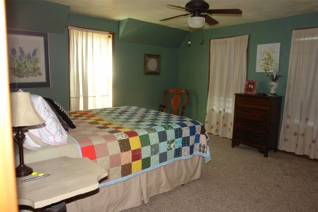 Bedroom with ceiling fan and carpet floors | Image 10