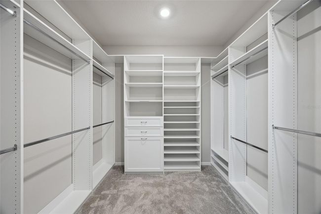 Custom designer walk in closet in Primary suite | Image 19