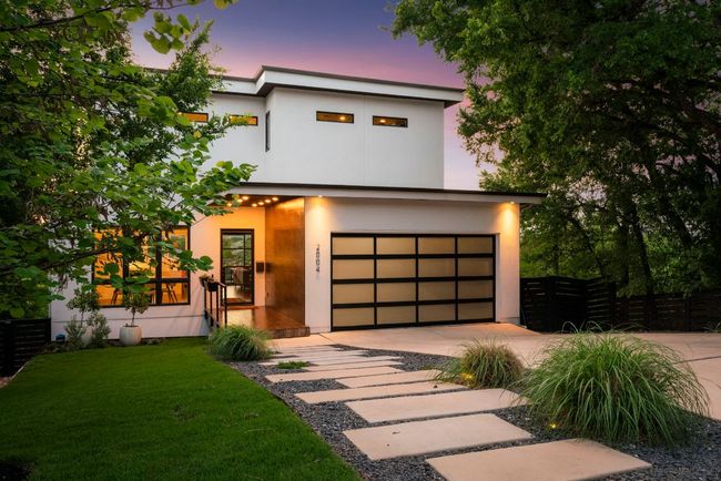 Covered entry with bronze tile, custom handrails, stained wood soffits with led lighting and custom steel Durango front door. | Image 40