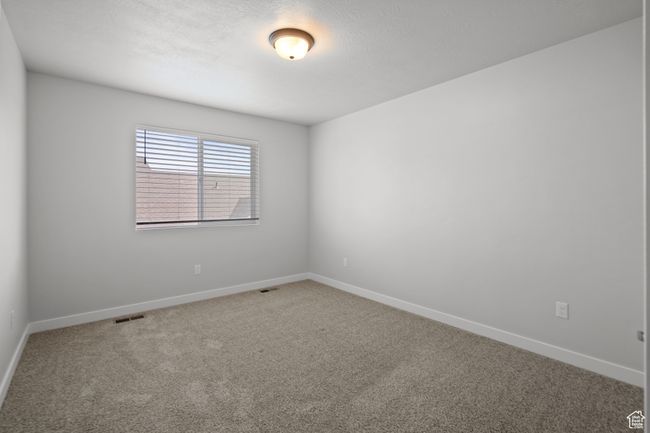 Carpeted spare room with baseboards | Image 34