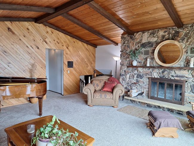Upper level living room with plush carpet, vaulted ceilings and a cozy floor to ceiling stone fireplace. | Image 20