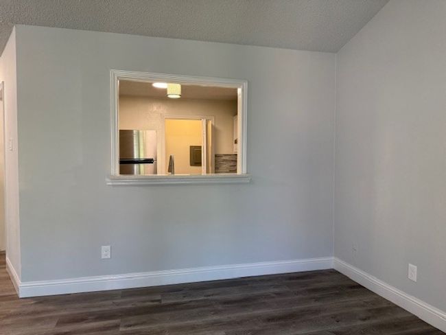 Spare room featuring dark wood-style flooring | Image 17
