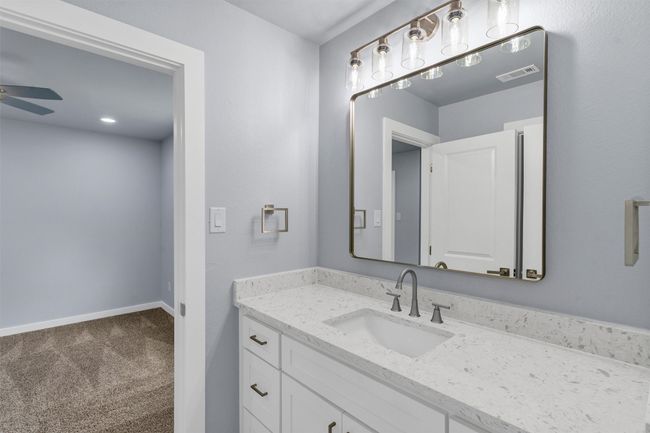 Bathroom with a ceiling fan and vanity | Image 33