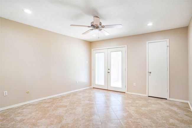 Empty room with french doors, a ceiling fan, light tile patterned flooring, recessed lighting, and baseboards | Image 6