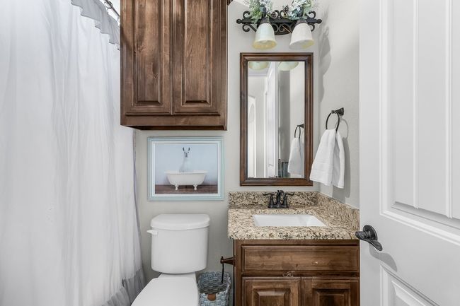 Full bathroom featuring vanity, toilet, and curtained shower | Image 25