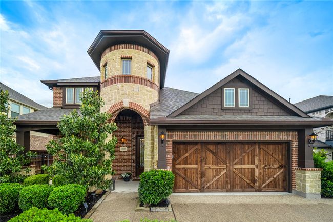 View of front facade featuring roof with shingles, brick siding, an attached garage, and asphalt driveway | Image 4