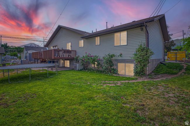 Back of house featuring a trampoline and a deck | Image 27