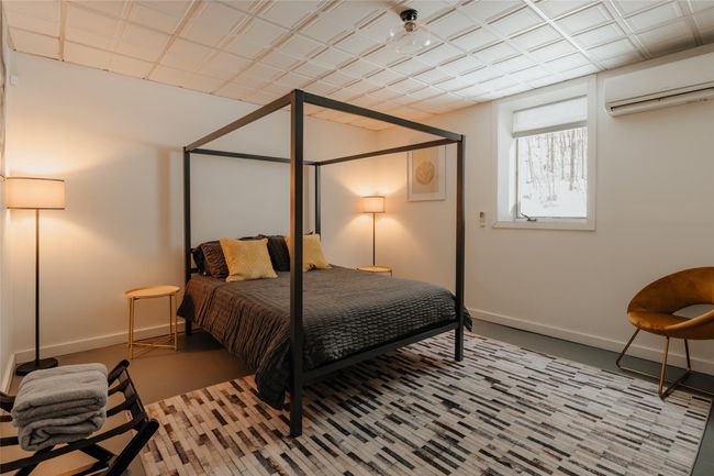 Basement room with a wall mounted AC | Image 27