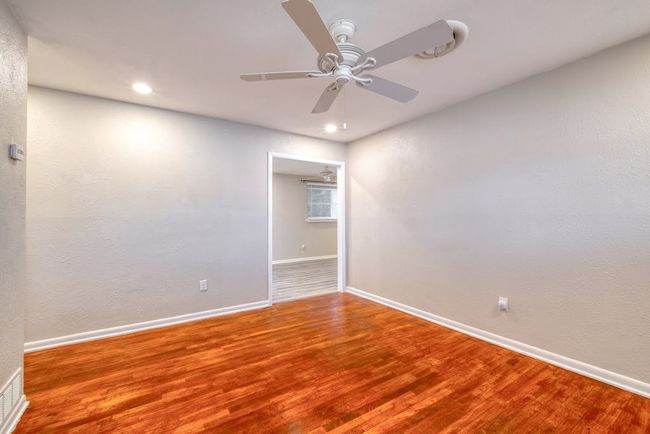 Living room featuring a ceiling fan, baseboards, wood floors, and recessed lighting | Image 5