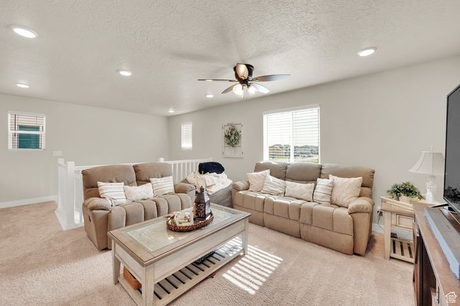 Living room with light carpet, a ceiling fan, recessed lighting, healthy amount of natural light, and baseboards | Image 19