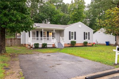 Ranch-style home featuring covered porch and a front yard | Image 3