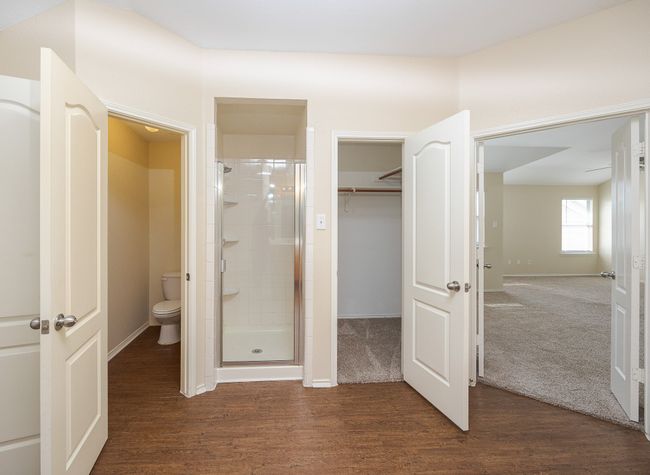 Master Bathroom featuring wood finished floors, vanity, bathtub / shower combination, and a spacious closet | Image 22